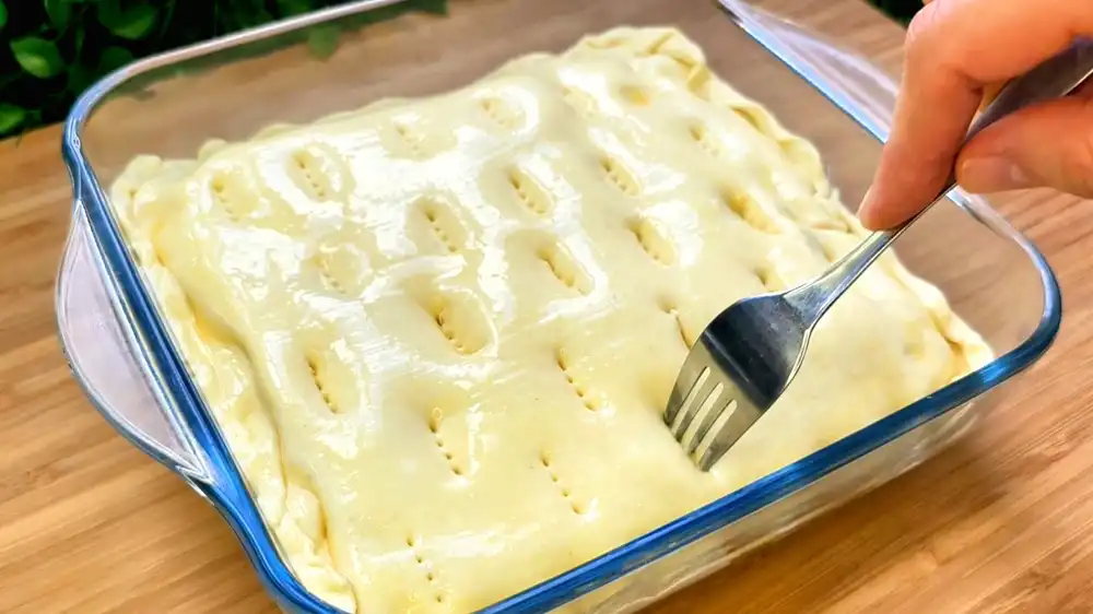 Detailansicht eines angeschnittenen Kuchenstücks, das die Schichten aus krossem Blätterteig, samtiger Mascarpone-Creme und in Kaffee getränkten Löffelbiskuits perfekt zeigt.